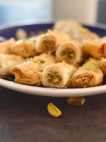 A close up of a plate of food, with Baklava rolls
