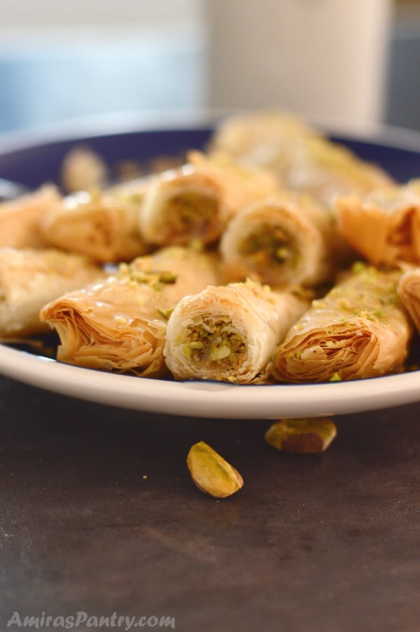 A close up of a plate of food, with Baklava rolls