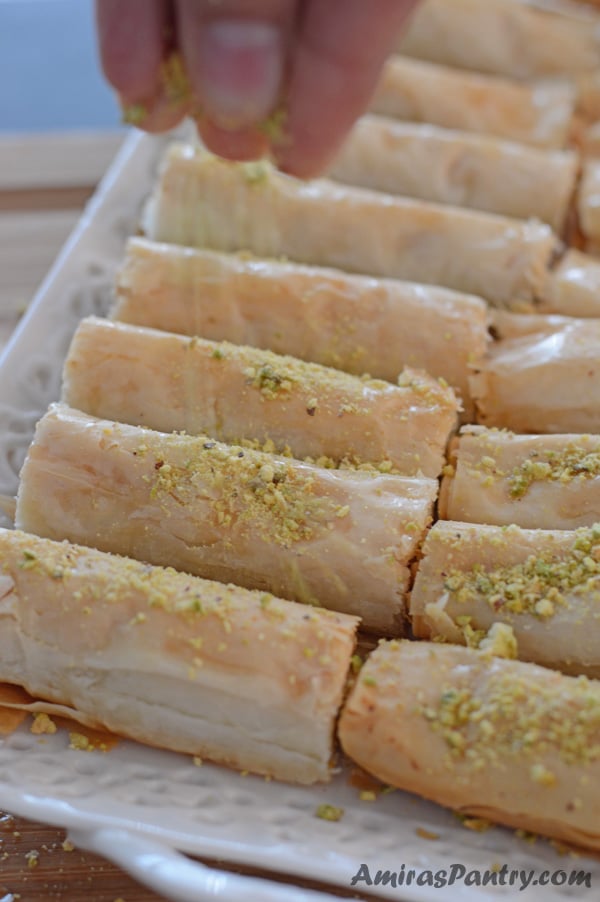 A close up of a plate of food, with Baklava rolls