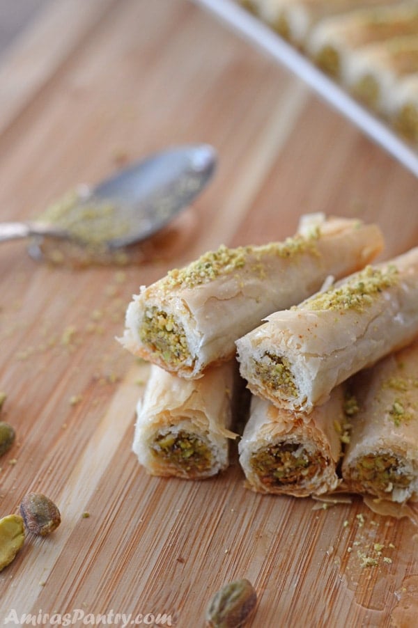 A photo for Baklava rolls on a wooden cutting board