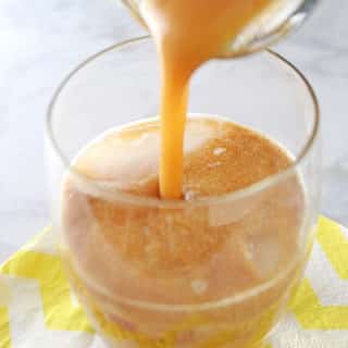 A photo showing a glass of Tamarind juice is being poured