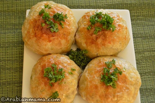A close up of bread stuffed and topped with Parsley 