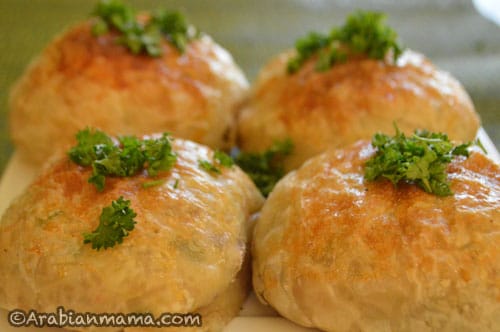 A close up of bread stuffed and topped with Parsley
