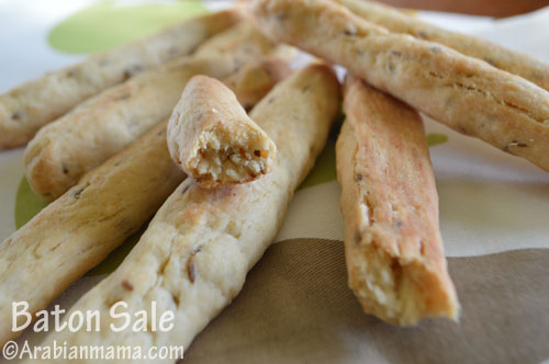 A close up of a plate with cut bread-sticks  