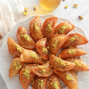 A plate of food on a table, with Qatayef