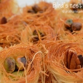 A close up of knafeh like bird's nest with nuts