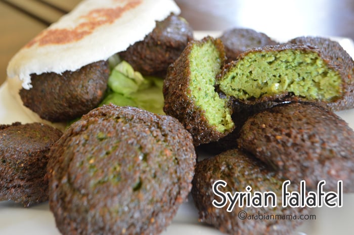 A close up of a plate of food, with Falafel and bread