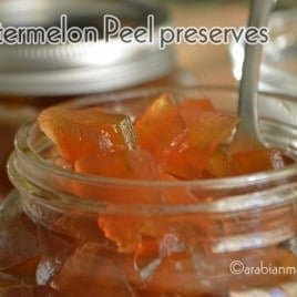 A close up of a jar with watermelon jam preserves