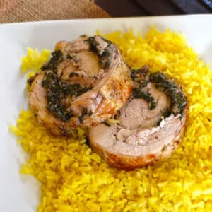 Two slices of chicken roll with yellow rice.