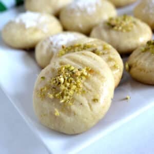 A close up look at one cookies garnished with crushed pistachios.