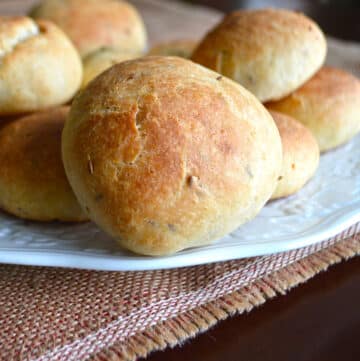 A stack of stuffed rolls on a white plate.