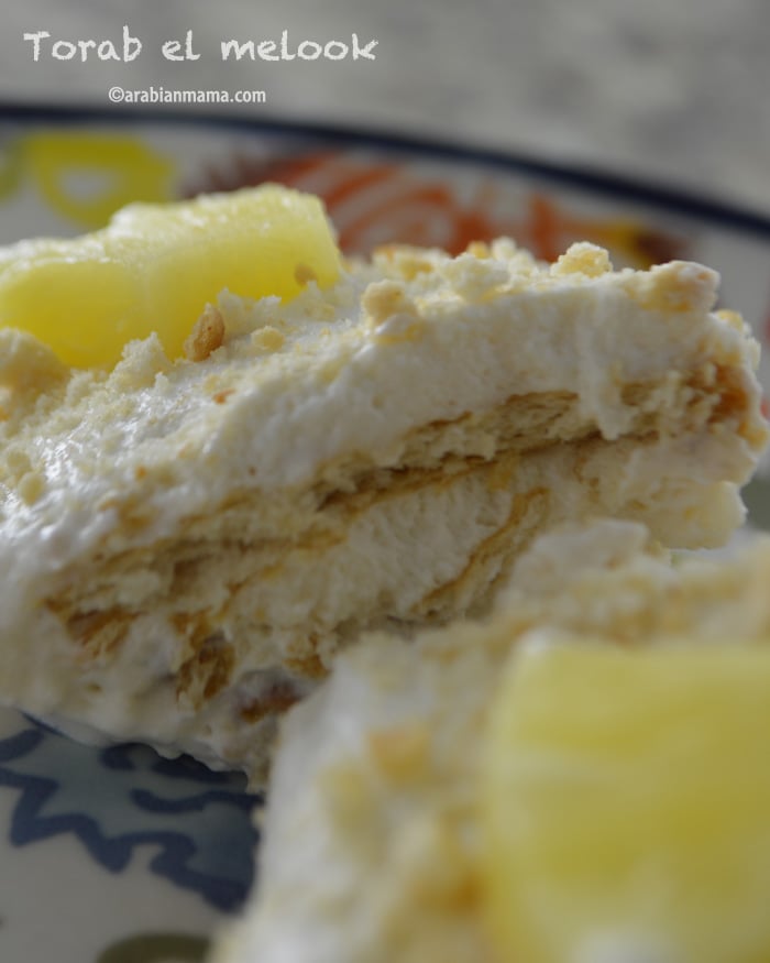A close up of a piece of cake with pineapples on top