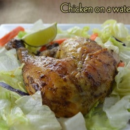 A close up of a plate of food, with Chicken and lettuce