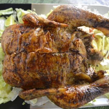 A whole roasted chicken on a serving platter.