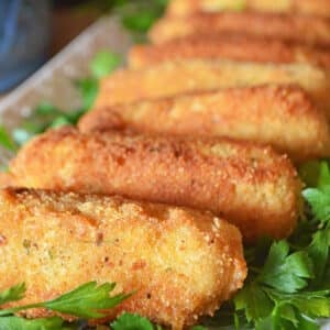 A white tray with potato croquette fingers.