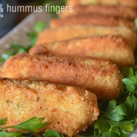 A close up of a plate of food, with Hummus Potato fingers