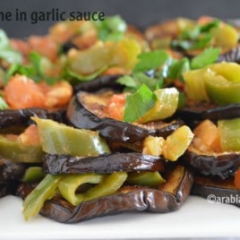 A close up of food, with garlic Aubergine and vegetables