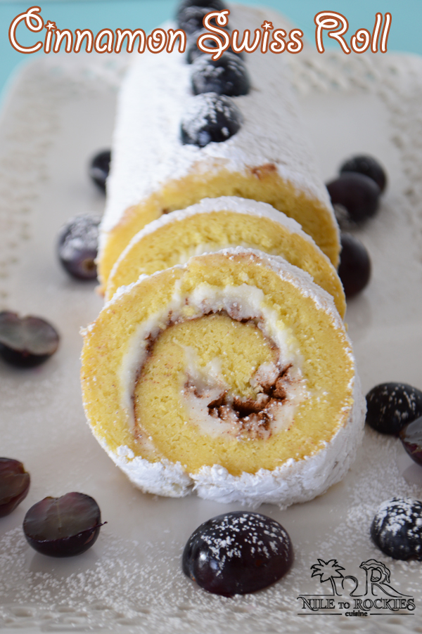 A piece of swiss roll cake covered in powdered sugar