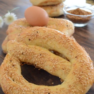 A Simit bread on a table with spices and eggs