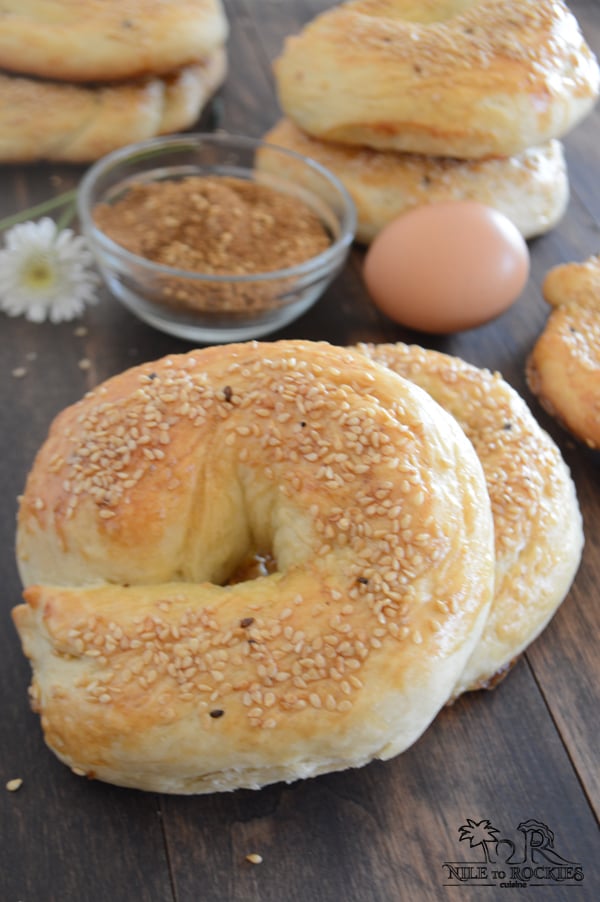 A Simit bread on a table with spices and eggs