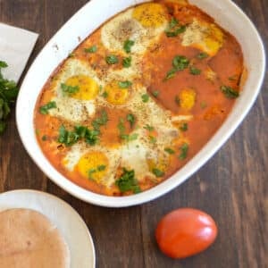 A wgite oven dish with shakshouka.