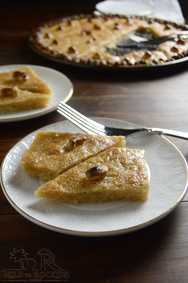 A piece of cake on a plate, with Basbousa and Nut