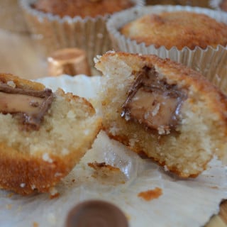 Rolo Basbousa like cupcake opened from middle in a plate, with chocolate and caramel