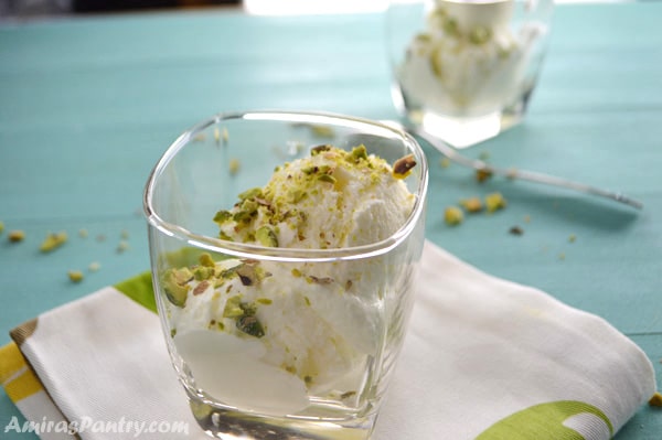 A cup with scoops of Lebanese booza ice cream topped with pistachios.