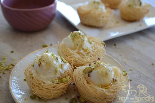 A plate of food on a table, with Knafeh and Ice Cream