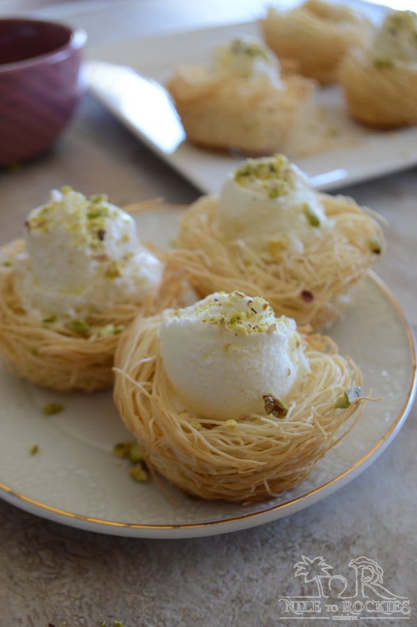 A plate of food on a table, with Knafeh and Ice Cream