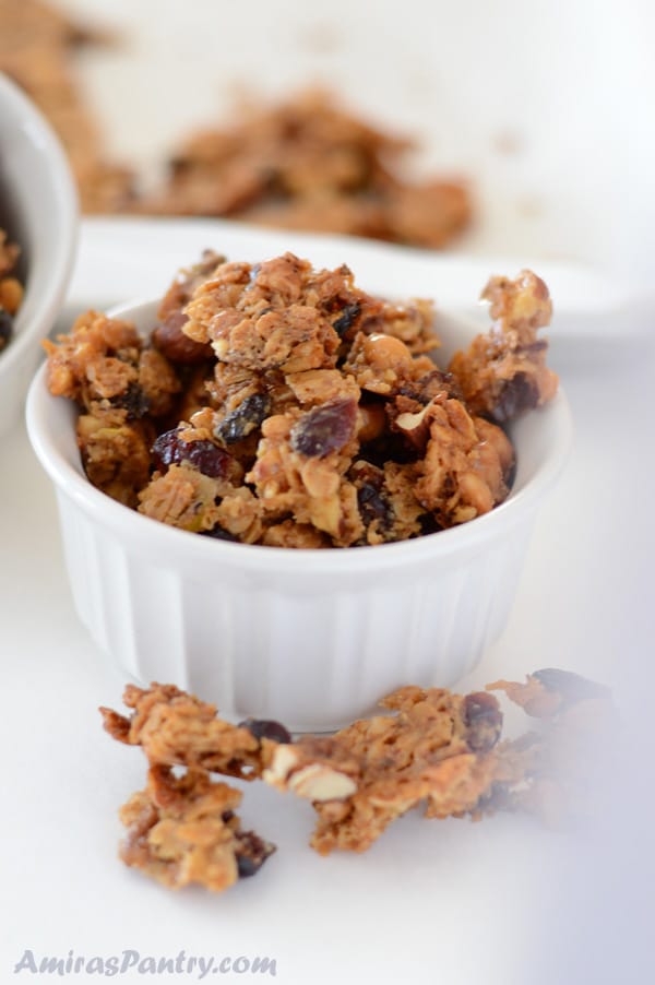 A small bowl of food on a plate, with baklava Granola bites