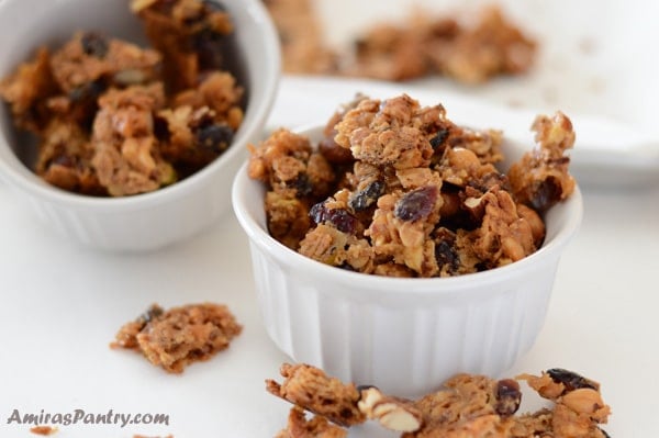 Baklava granola bites/clusters packed in a ramekin with another ramekin in the back.