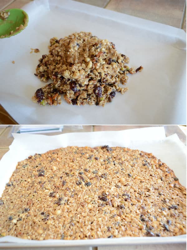 Granola mixture is spread in a baking sheet and getting ready to put in the oven.