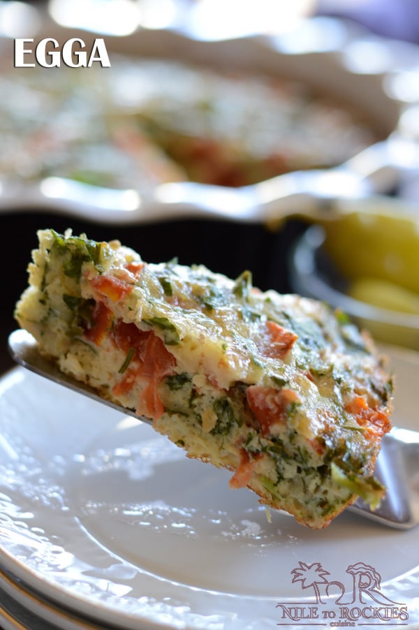 A close up of a piece of Frittata on a plate, with Eggs and vegetables