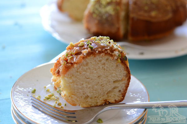 A close up of a piece of cake with nuts and fork