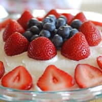 A cake with fruit on top of a table