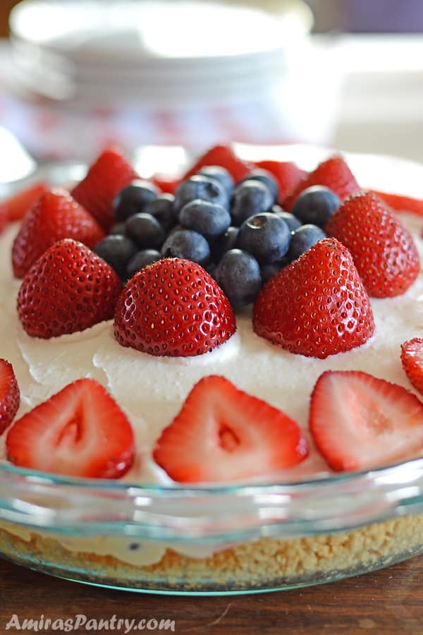 A cake with fruit on top of a table