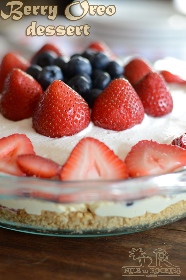 A close up of a cake on a plate, with berries and frosting