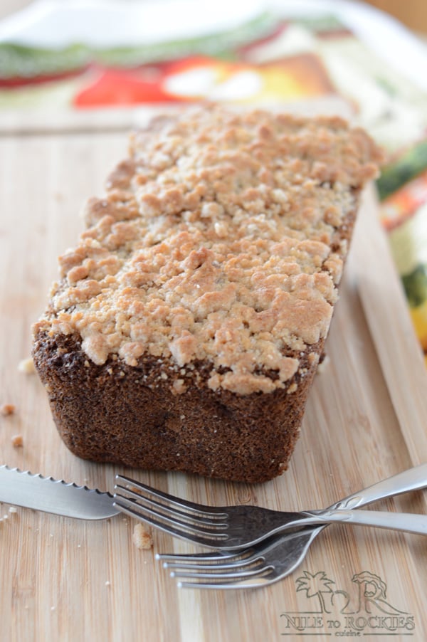 A piece of bread loaf on a wooden board and fork