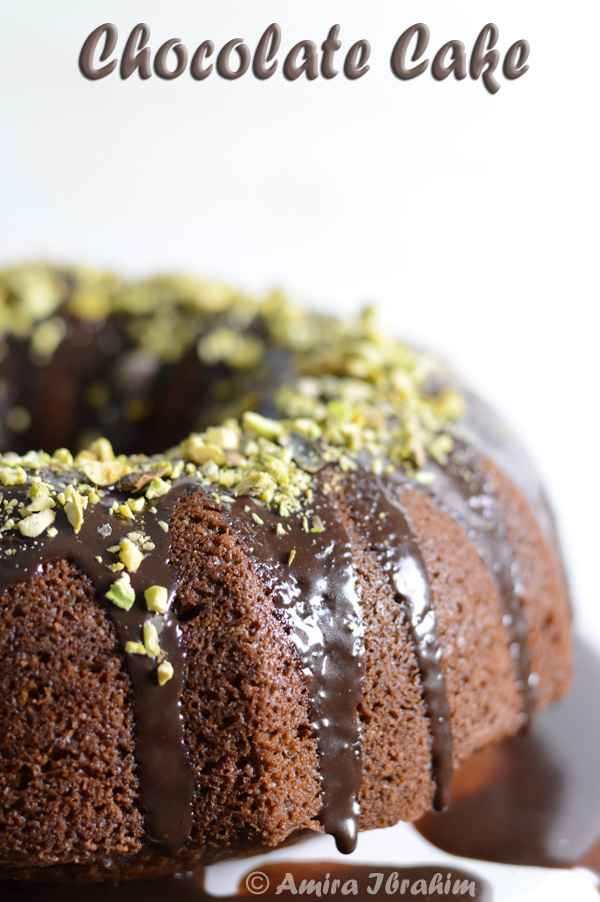 A close up of a cake covered in chocolate and nuts