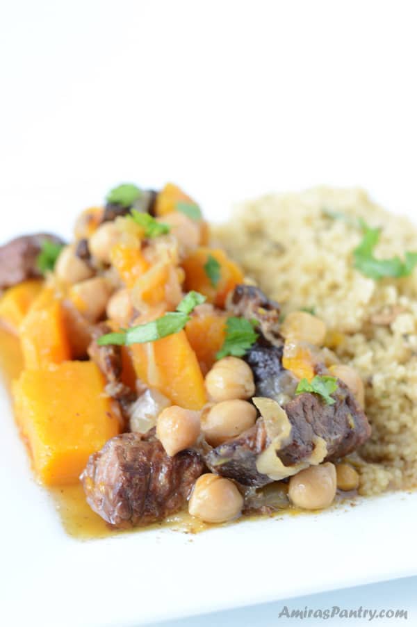 A plate of food with Couscous, vegetables and beef