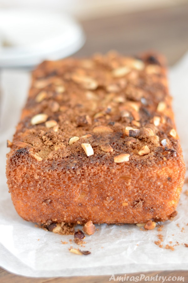 A piece of Cinnamon cake on a plate, with Nuts