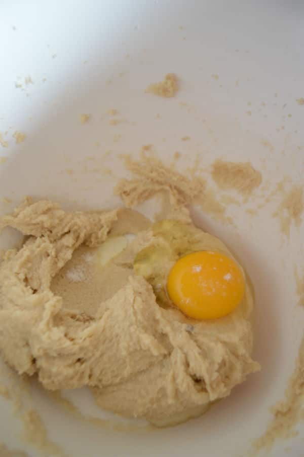A photo showing a bowl of dough and egg