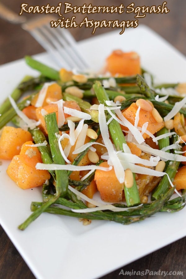 A close up of a plate of food, with butternut squash and asparagus