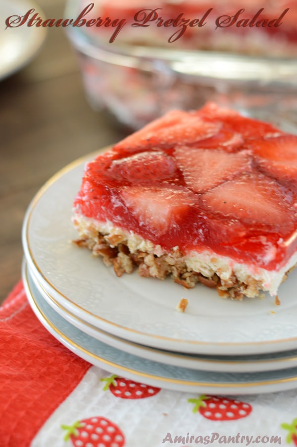 A piece of pretzel strawberry cake on a plate