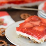 A piece of strawberry pretzel cake on a plate