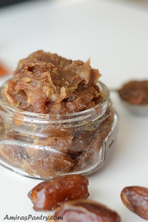 A close up of a jar with date paste