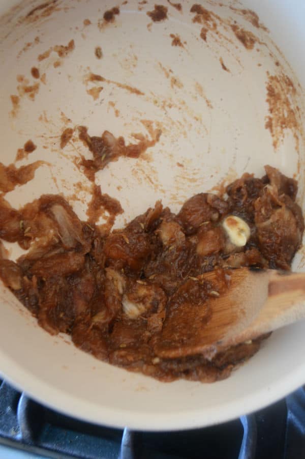 A close up of date paste and spoon in a bowl
