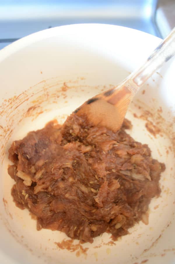 A bowl of food with a spoon and date paste