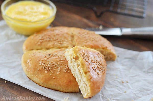 A bread on a paper sheet and knife